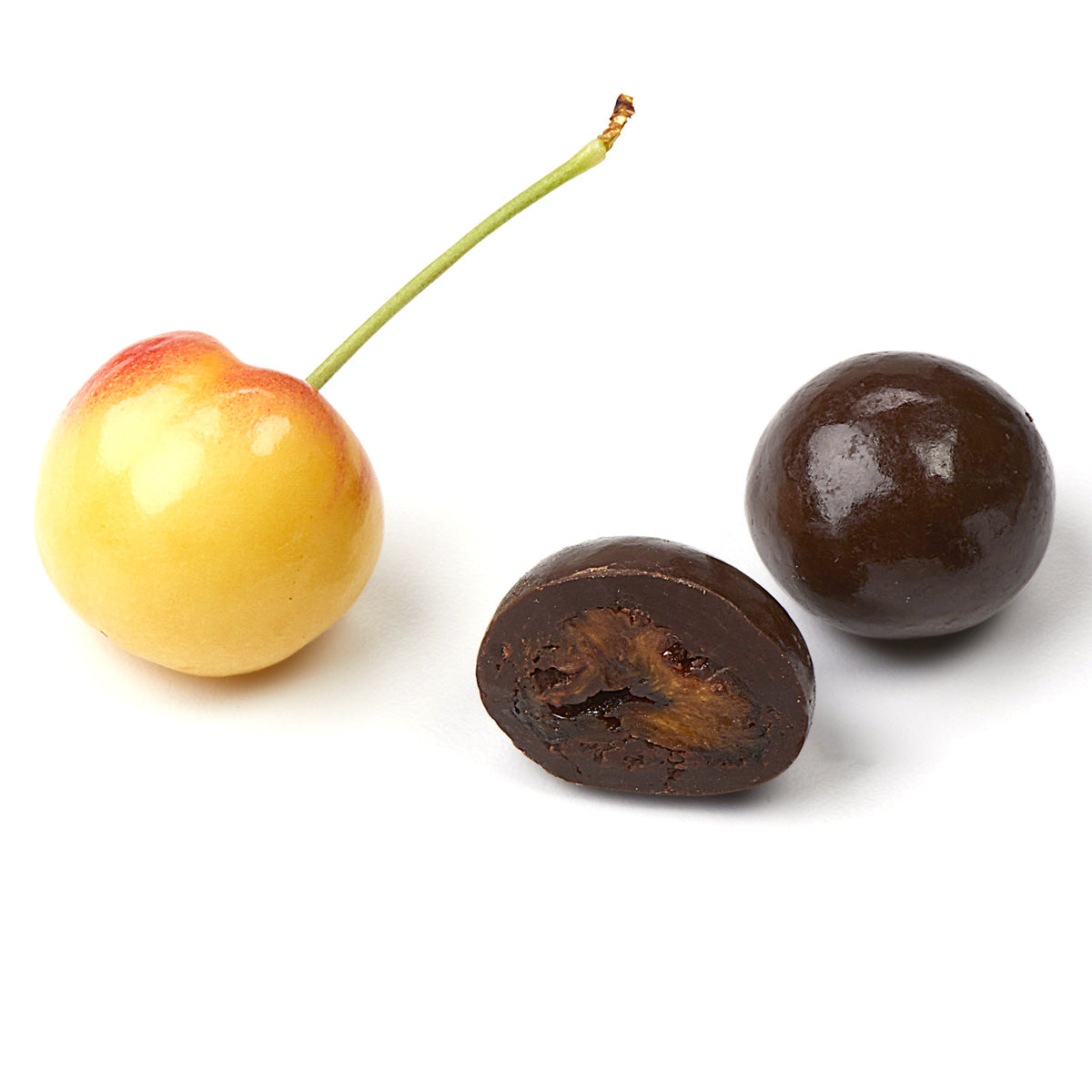 Fresh cherry and cross-section of chocolate covered dried cherry