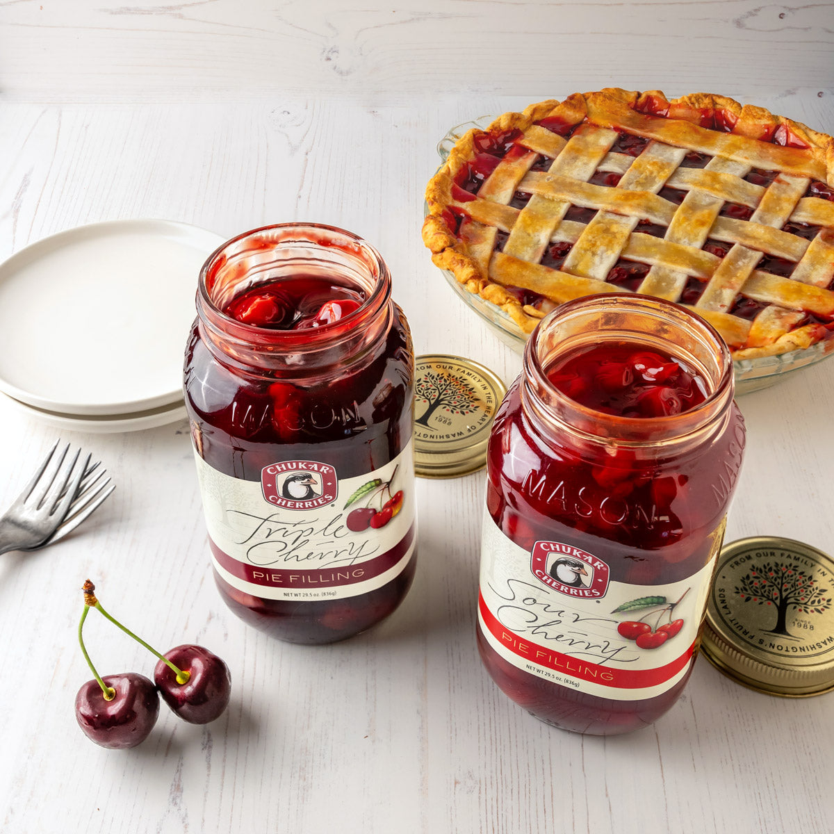 Open jars of sour cherry and triple cherry pie filling