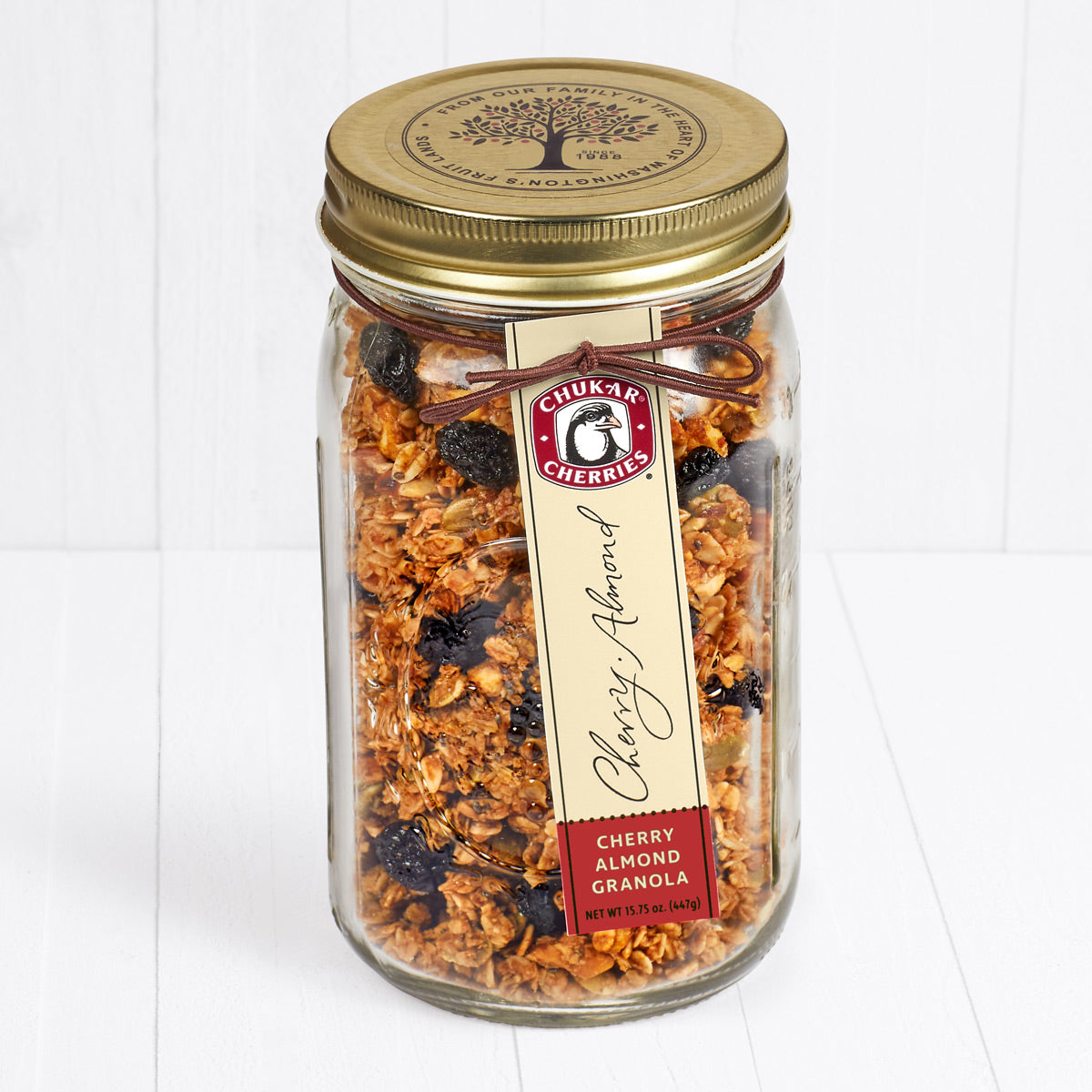 Cherry almond granola in closed farm jar with gold lid 