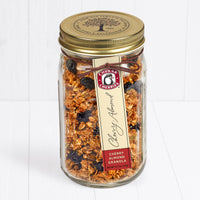 Cherry almond granola in closed farm jar with gold lid 