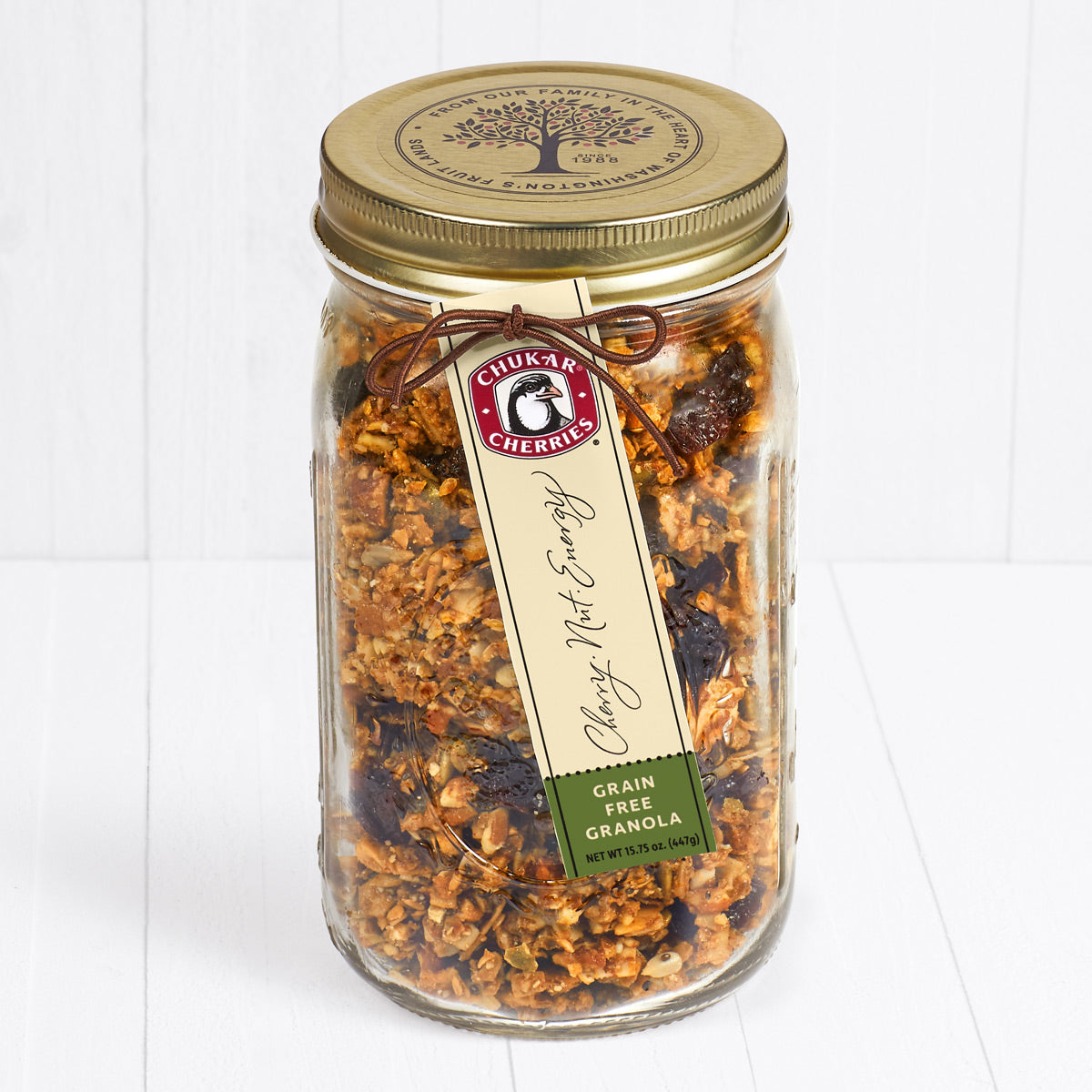 Grain free cherry nut energy granola in an open glass farm jar