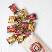 Twelve pure energy snack packs spilling out of cloth bag
