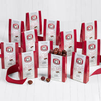 One open and eleven closed boxes of happy holidays chocolate cherry quartet