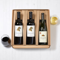 One chardonnay bottle and glass of wine, two red blend bottles and glass of wine