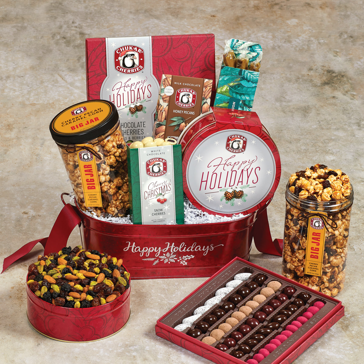 Holiday bounty gift basket includes holiday original assortment, cherry caramel twists, honey pecans, no sugar added triple cherry nut tin, white chocolate snow cherries, and cherry pecan caramel corn big jar
