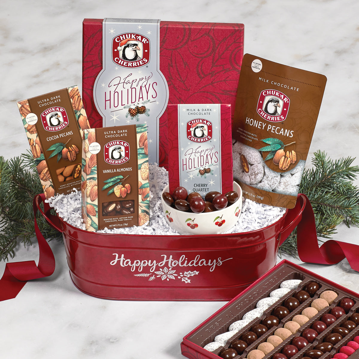 Image of open happy holidays original assortment and happy holidays cherry quartet. Closed honey pecans, cocoa pecans, and vanilla almonds also shown in holiday cherry and nut gift basket