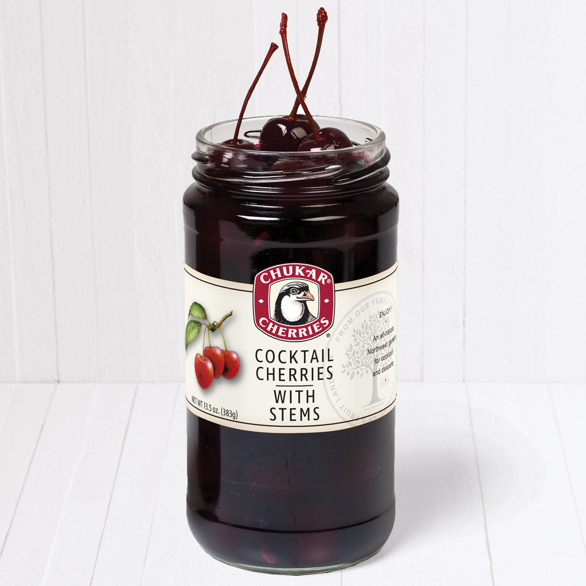 Open jar of cocktail cherries with stems