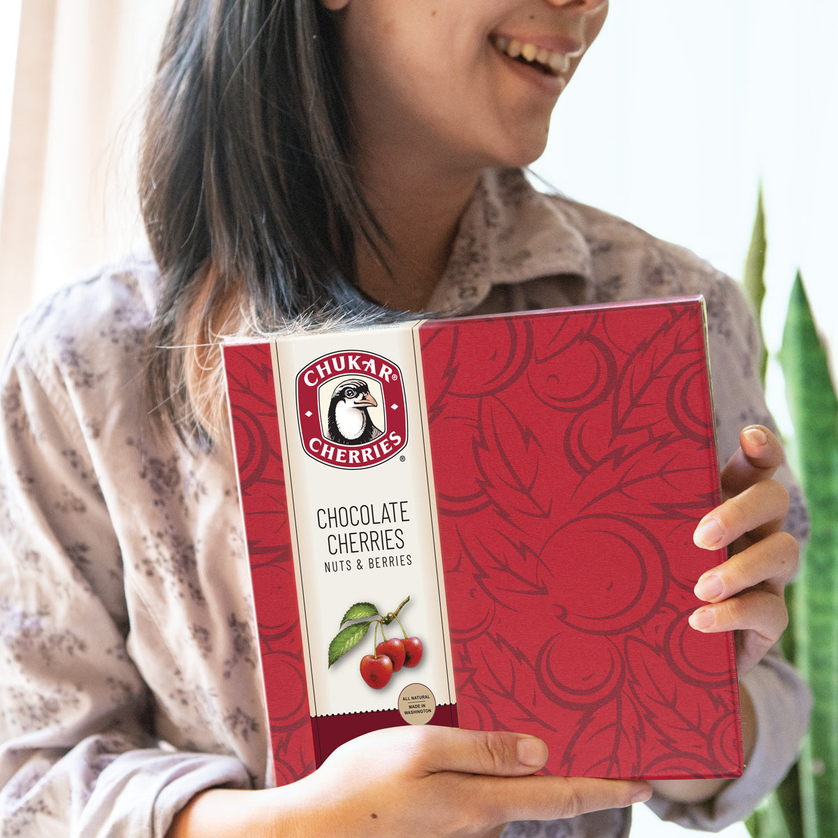 Closed original assortment being held by smiling woman
