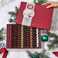 Open cherry christmas grand chocolate assortment gift box showing ten rows filled with chocolate covered cherries, nuts, and berries.