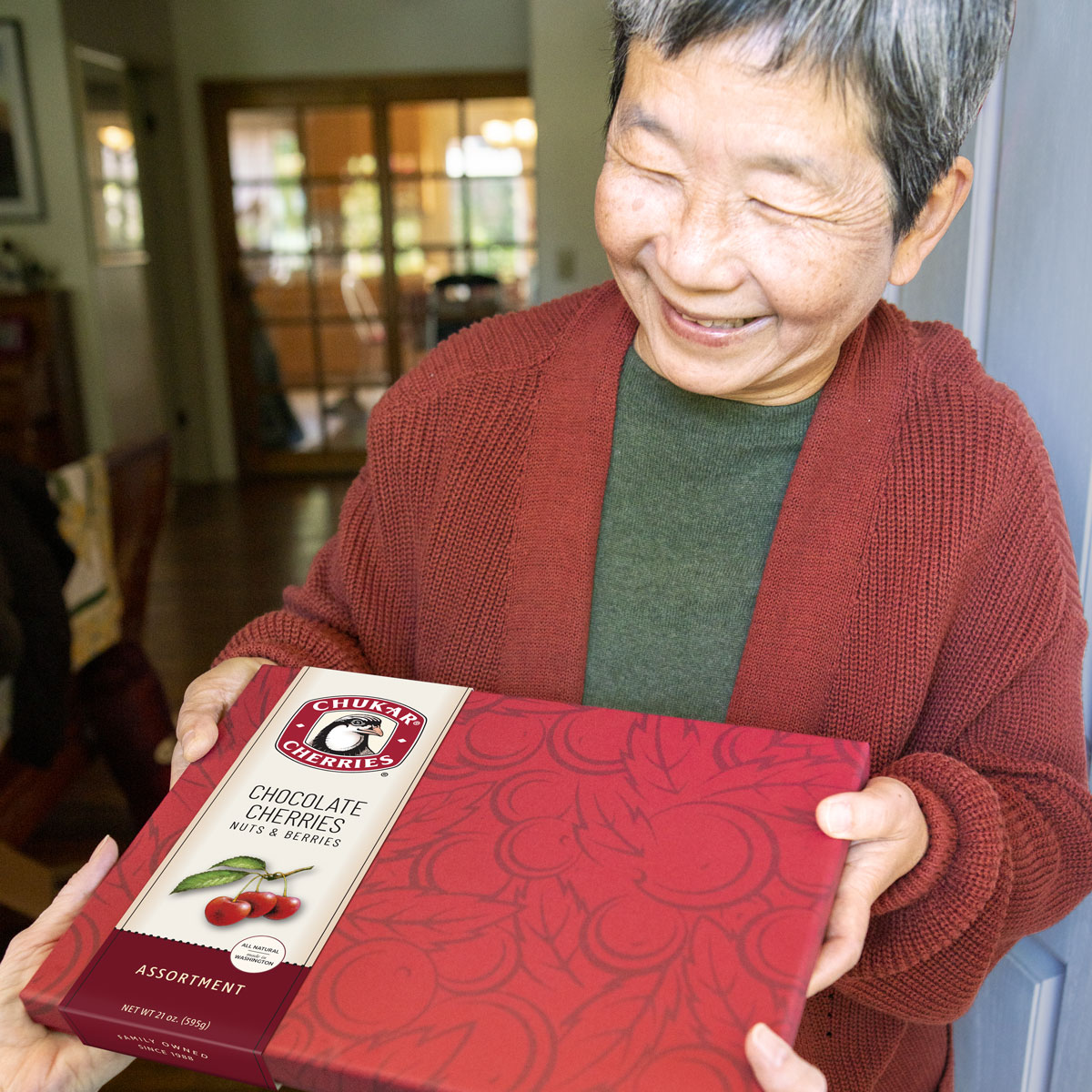 Women smiling as she holding a grand assortment