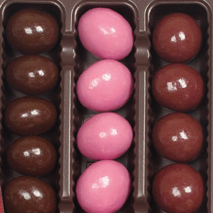 Box of pink and brown chocolate cherries