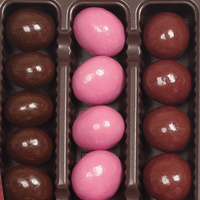 Box of pink and brown chocolate cherries