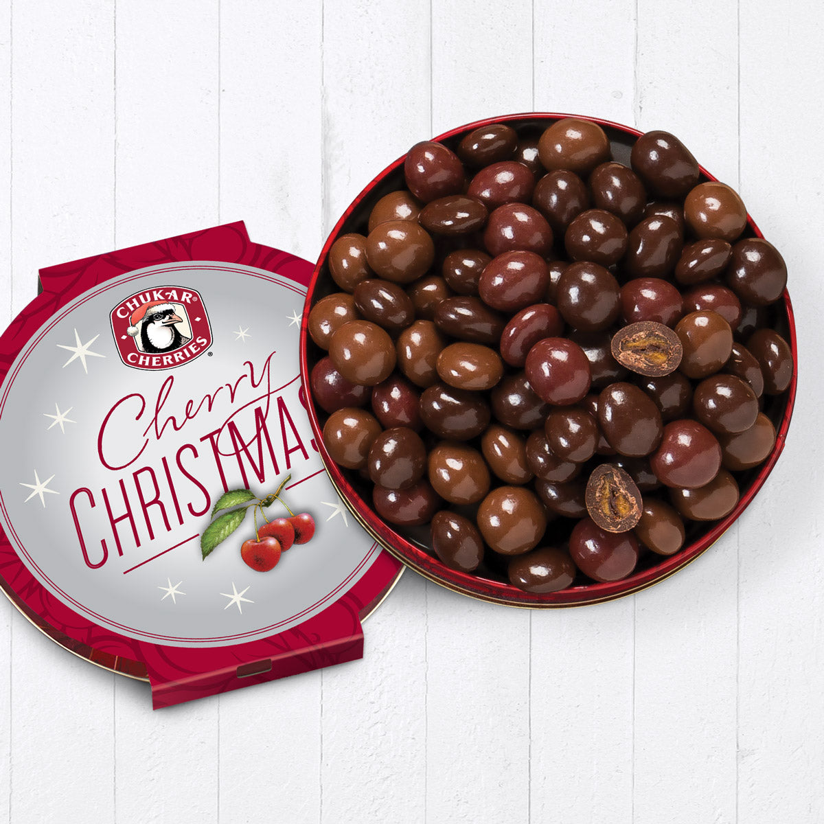 Open cherry christmas quartet tin showing whole dark chocolate cabernet cherries, milk chocolate cherry bings, classic milk chocolate cherries, and whole and cut ultra dark chocolate amaretto rainiers