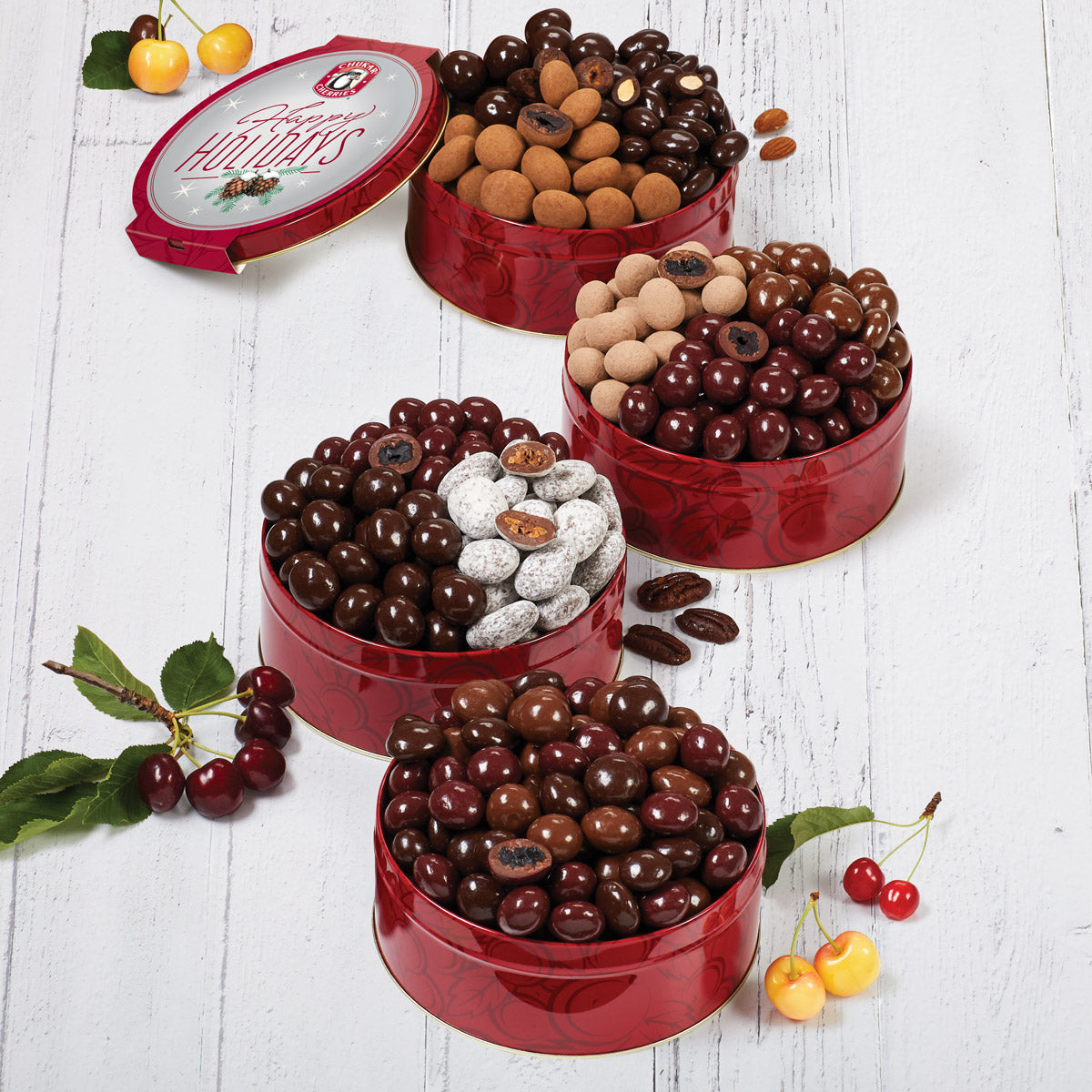 Collection of four holiday chocolate cherry and nut tins