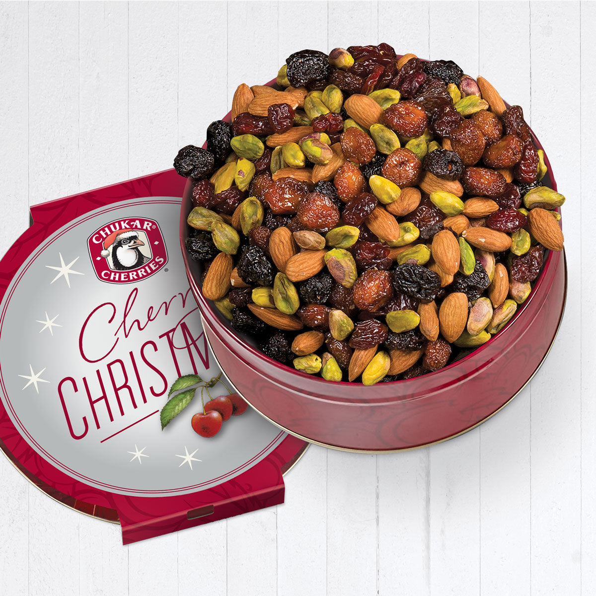 Open cherry christmas triple cherry nut tin showing naturally dried bing, rainier, and tart cherries mixed with dry roasted almonds and pistachios