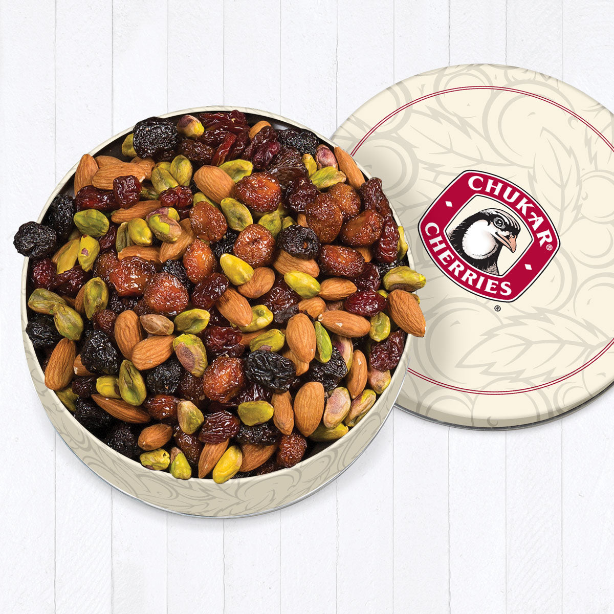 Cream color gift tin filled with triple cherry nut