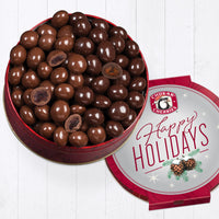Open happy holidays milk and dark chocolate classic gift tin with four cut pieces on top