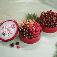 Collection of two holiday chocolate cherry, nut, and berry tins