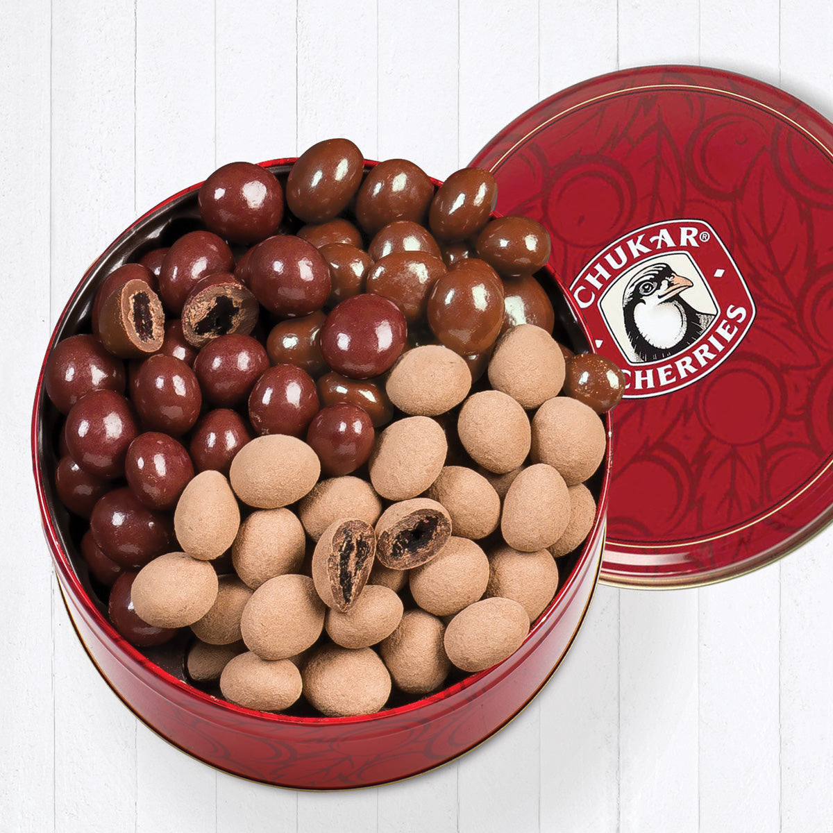 Open milk chocolate tin with cross sections of chocolate cherries