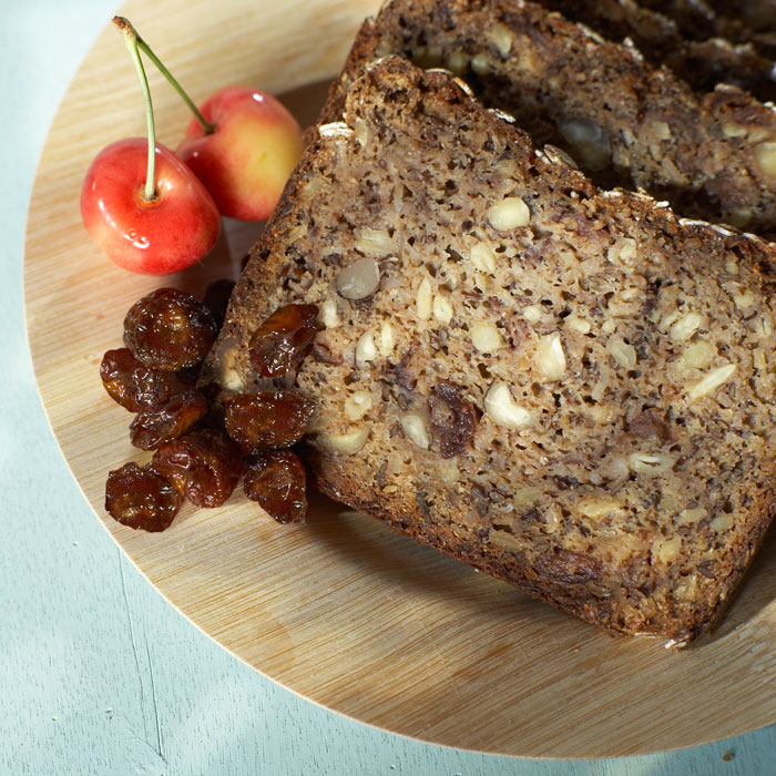 Nutty quick bread garnished with dried and fresh Rainier cherries