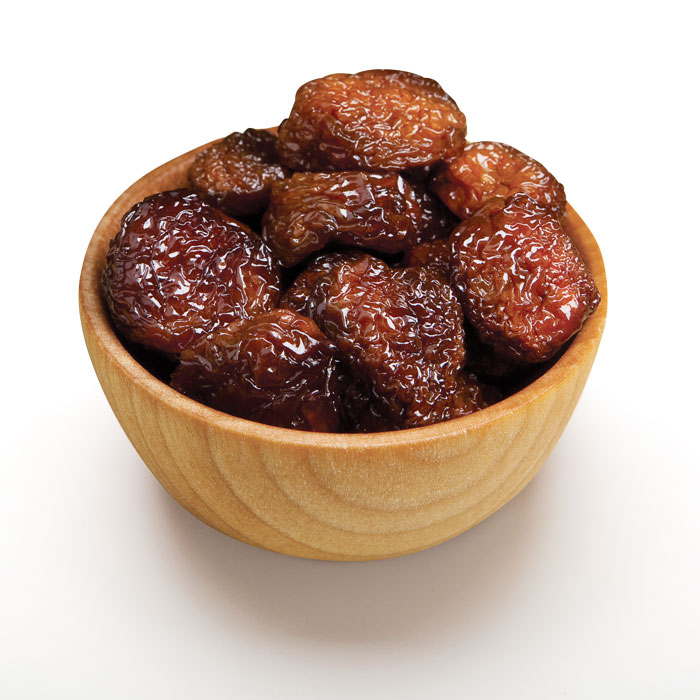 Dried whole rainier cherries in wood bowl