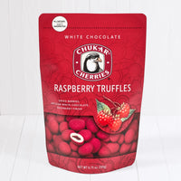 Closed bag shows whole and cut white chocolate raspberry truffles 