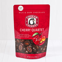 Whole and cut chocolate cherry quartet cherries shown in closed resealable bag