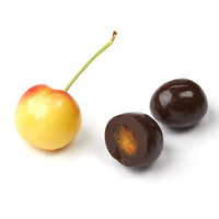 Fresh cherry and cross-section of chocolate covered dried cherry