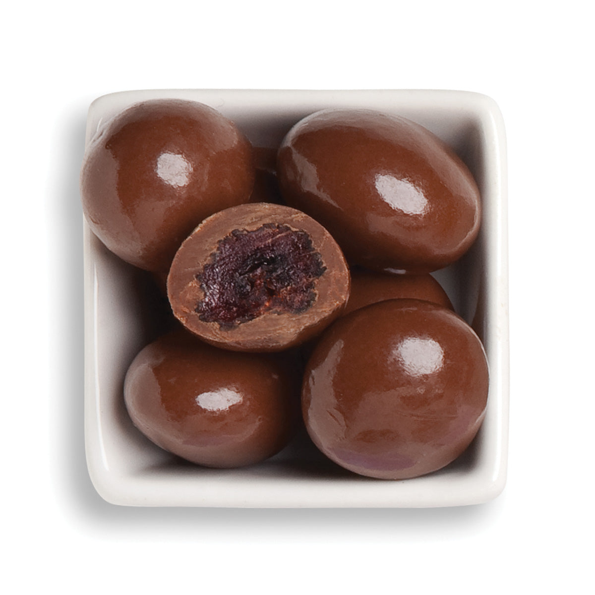 Whole and cut classic milk cherries in bowl