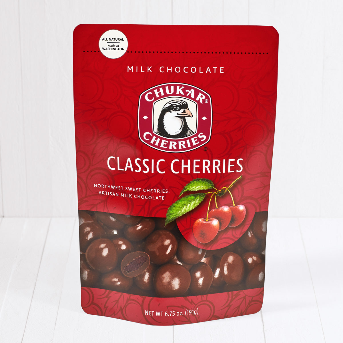 Whole and cut milk chocolate classic milk cherries shown in closed resealable bag