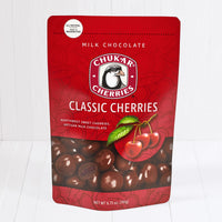 Whole and cut milk chocolate classic milk cherries shown in closed resealable bag