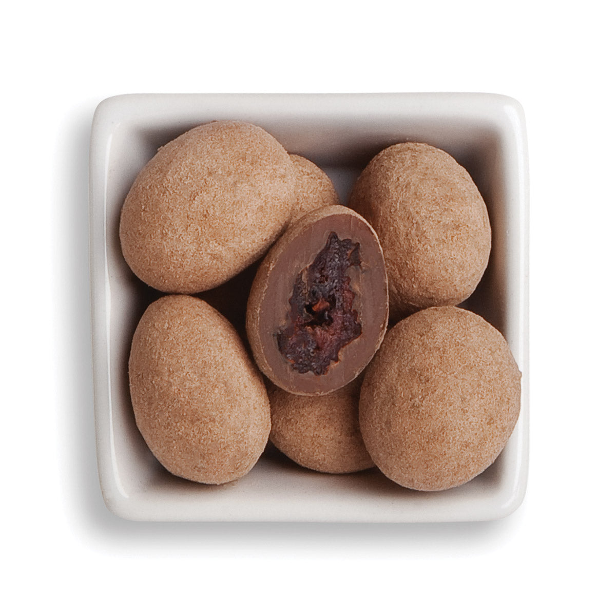 Whole and cut milk chocolate truffle cherries in white bowl 