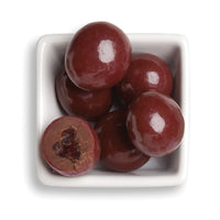 Whole and cut cherry bings in white bowl 