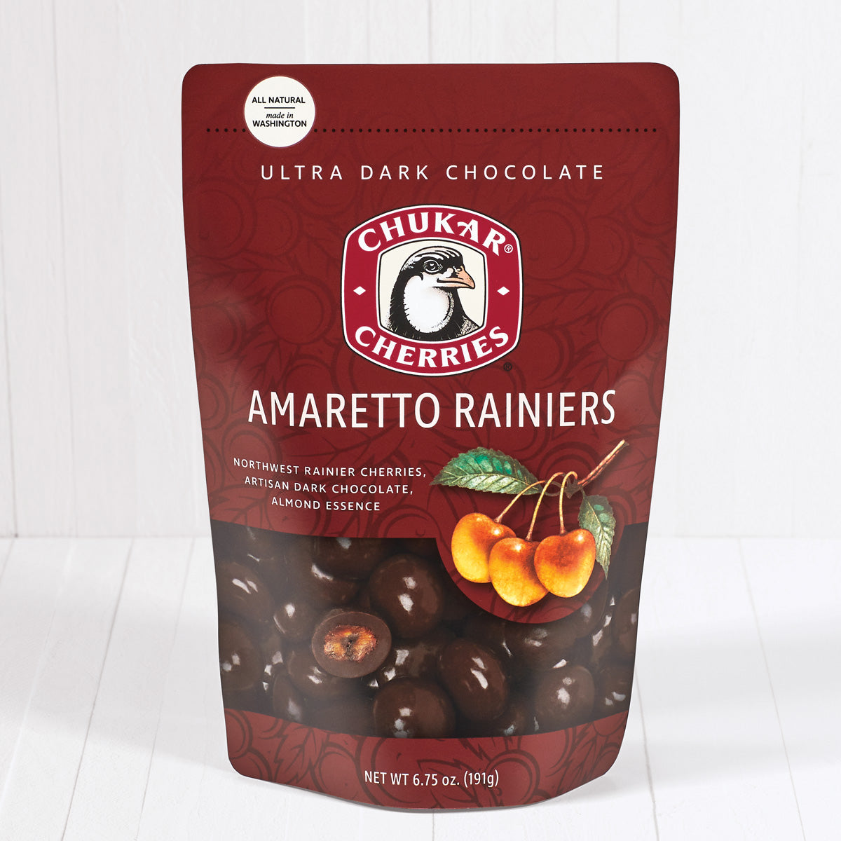 Whole and cut ultra dark chocolate amaretto rainiers shown in closed resealable bag