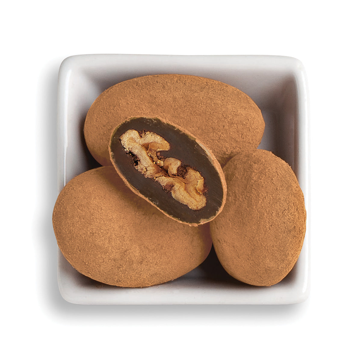 Whole and cut cocoa pecans in white bowl