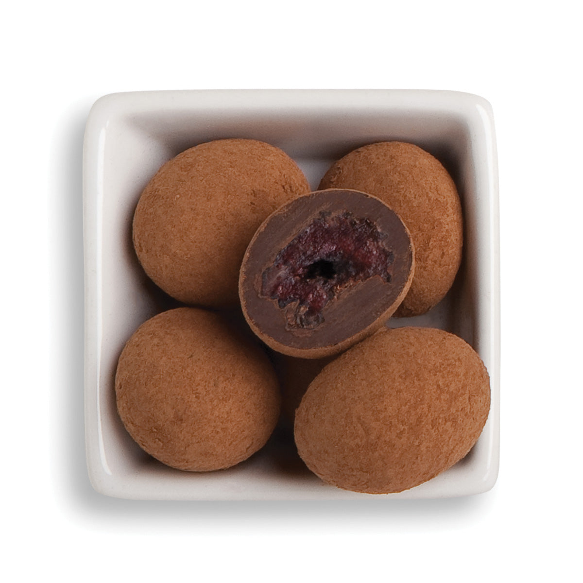 Whole and cut black forest cherries in bowl