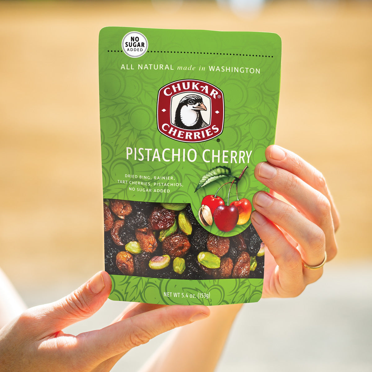 Hands holding pistachio cherry bag