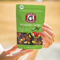Hands holding pistachio cherry bag