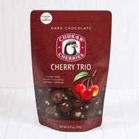 Whole and cut dark chocolate cherries shown in closed resealable bag