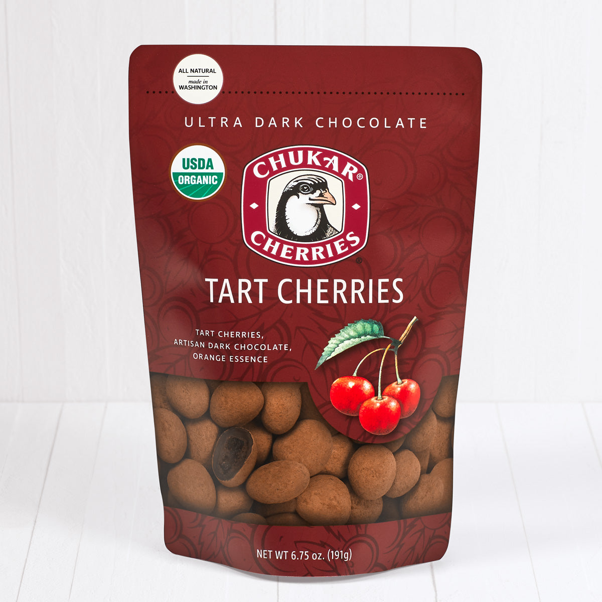 Whole and cut organic ultra dark tart cherries shown in closed resealable bag