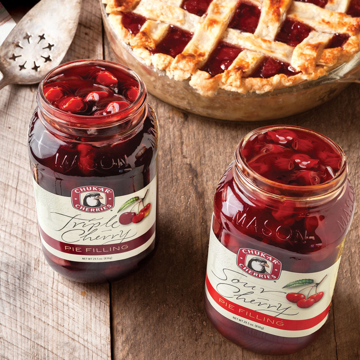 Open jars of sour cherry and triple cherry pie filling