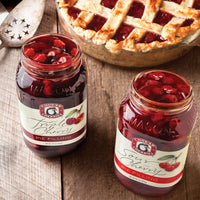 Open jars of sour cherry and triple cherry pie filling
