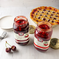 Open jars of sour cherry and triple cherry pie filling