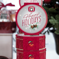 Stack of four happy holidays trio tins; front and side of tins are shown
