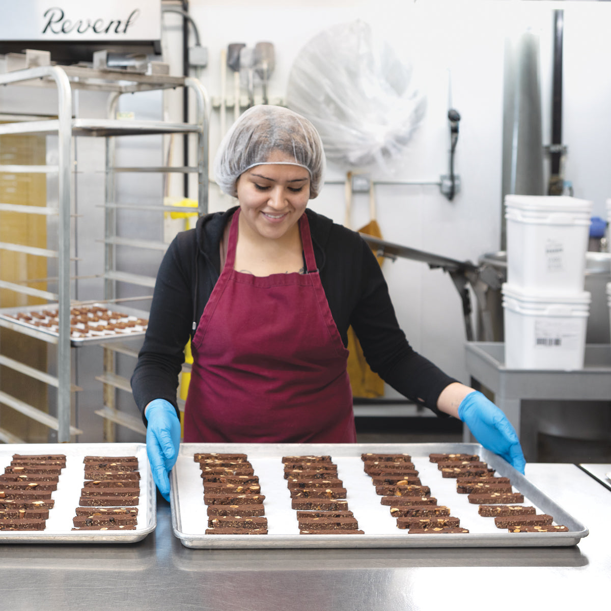 Production worker baking chocolate cherry almond biscotti in Chukar's kitchen